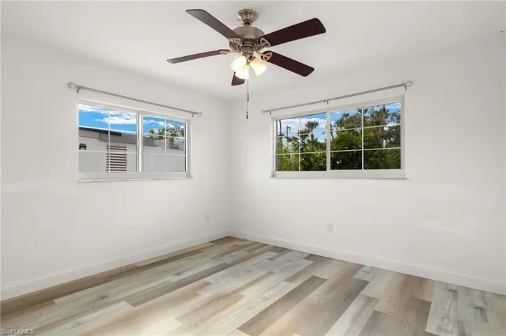 Spare room with ceiling fan and light hardwood / wood-style floors