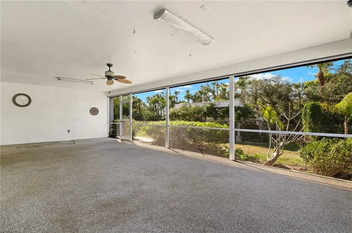 Unfurnished sunroom with ceiling fan