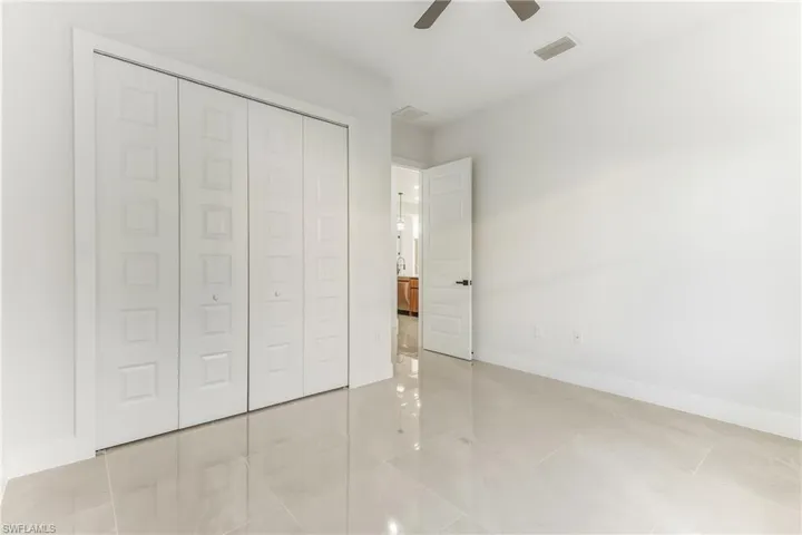 Unfurnished bedroom featuring a closet and ceiling fan