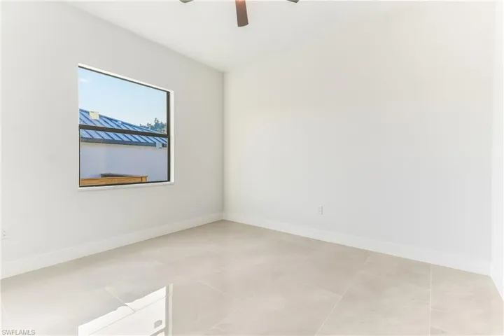 bedroom featuring baseboards and ceiling fan