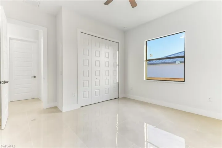 bedroom with a ceiling fan and a closet