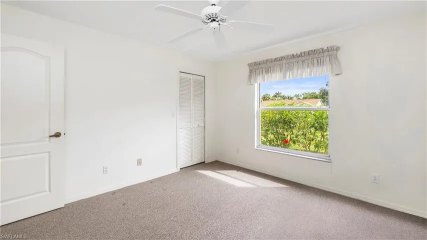 Unfurnished bedroom with carpet floors, a closet, and a ceiling fan