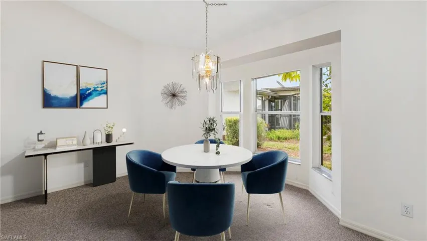 Virtually Staged to show full potential of living space. Carpeted dining space featuring baseboards and lofted ceiling