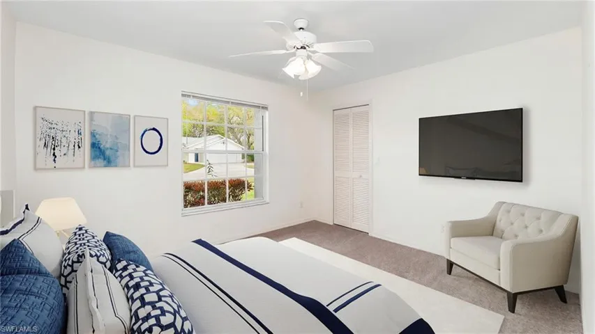 Virtually Staged to show full potential of living space. Bedroom with carpet floors, a ceiling fan, and a closet