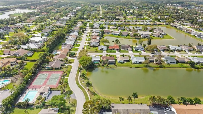 Aerial perspective of suburban area featuring a nearby body of water