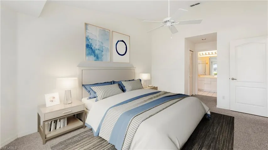 Virtually Staged to show full potential of living space. Carpeted bedroom featuring lofted ceiling, ensuite bathroom, and a ceiling fan