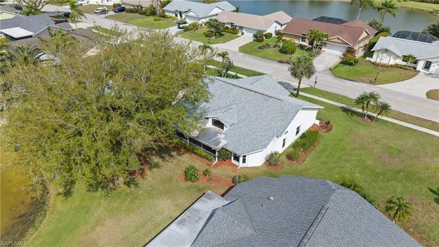 Aerial perspective of suburban area featuring a large body of water