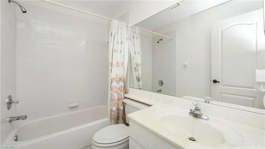 Bathroom with vanity and shower / bath combo with shower curtain