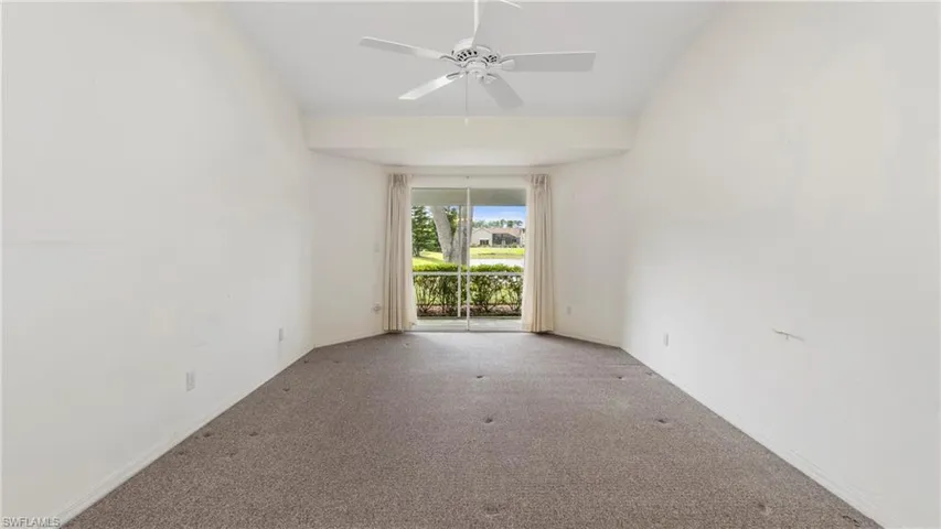Empty room featuring ceiling fan and carpet floors