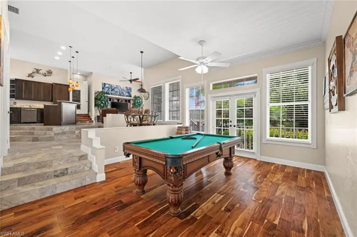 Playroom featuring french doors, pool table, wood finished floors, and ceiling fan