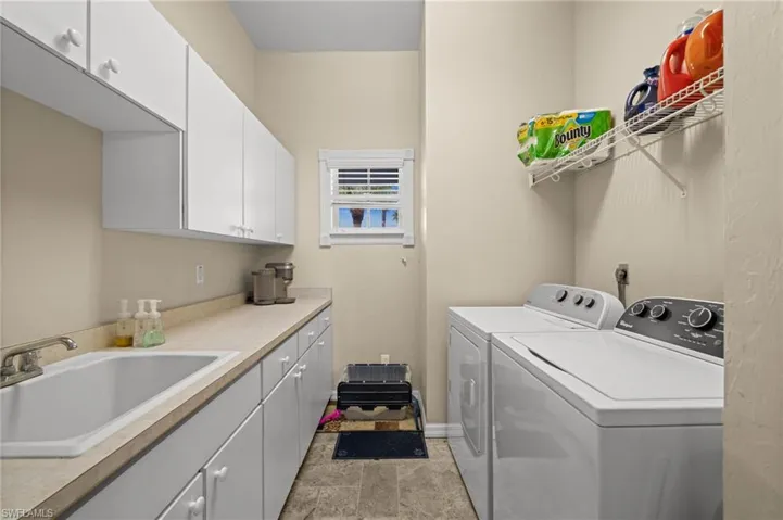 Washroom with cabinet space and washer and dryer