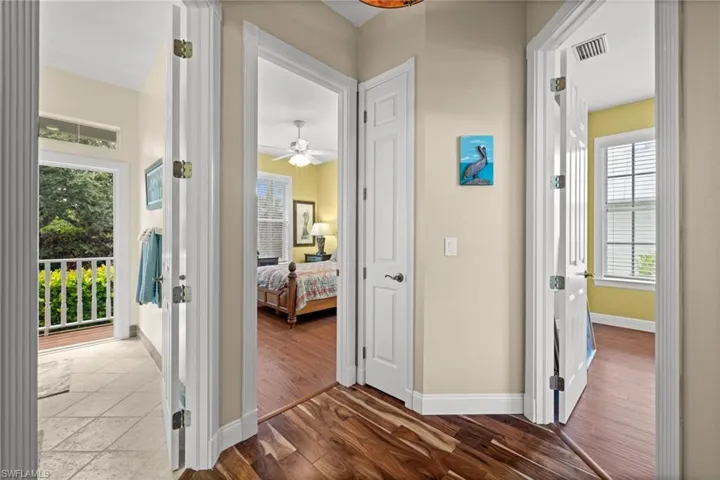 Hallway featuring dark wood finished floors and baseboards