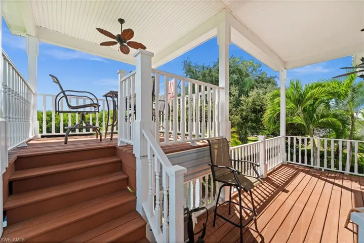 Wooden terrace featuring a ceiling fan