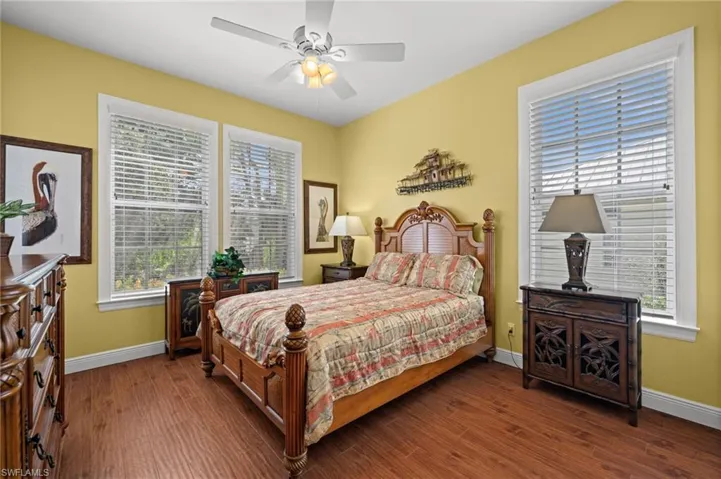 Bedroom featuring dark wood-style flooring and ceiling fan