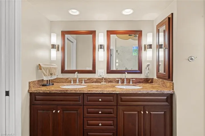 Full bathroom featuring double vanity and recessed lighting