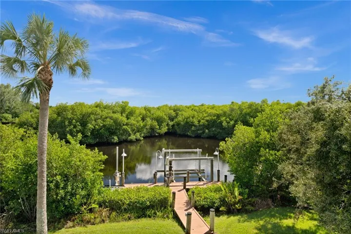 Dock featuring boat lift and a water view
