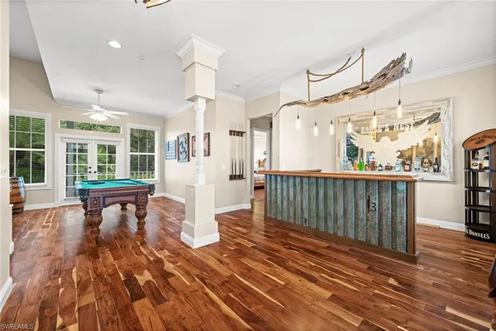 Rec room featuring french doors, dark wood-style floors, ornamental molding, billiards table, and recessed lighting