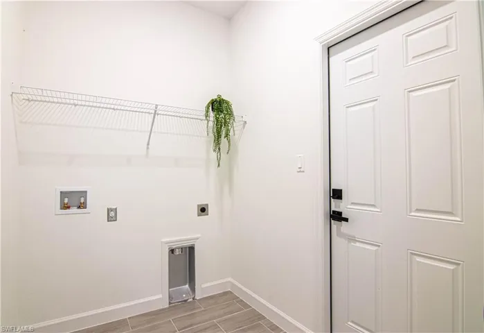 Washroom with washer hookup, electric dryer hookup, and light wood-type flooring
