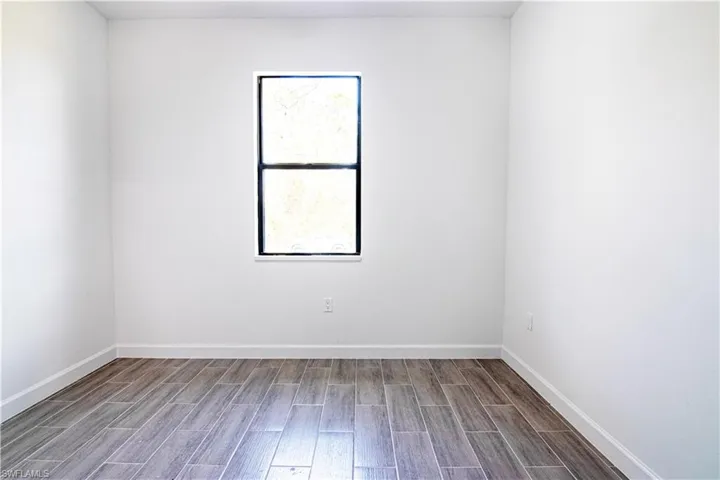 Unfurnished room with hardwood / wood-style floors
