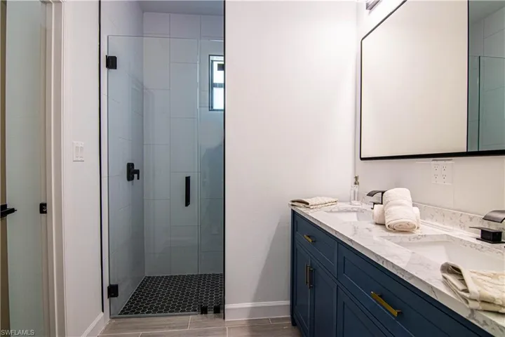 Bathroom featuring vanity and an enclosed shower