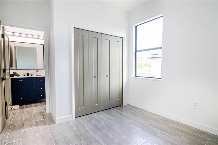 Unfurnished bedroom with light hardwood / wood-style floors and a closet