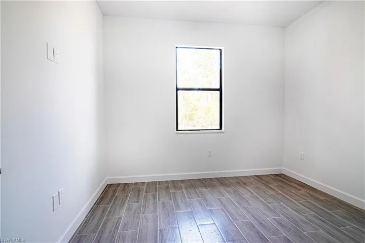 Empty room with hardwood / wood-style floors