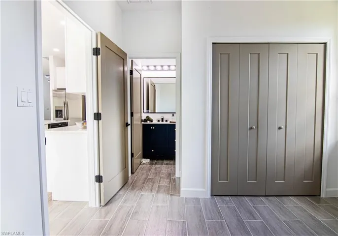 Hall with hardwood / wood-style floors