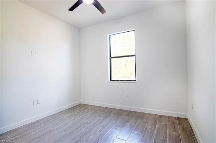 Empty room featuring ceiling fan and light hardwood / wood-style flooring