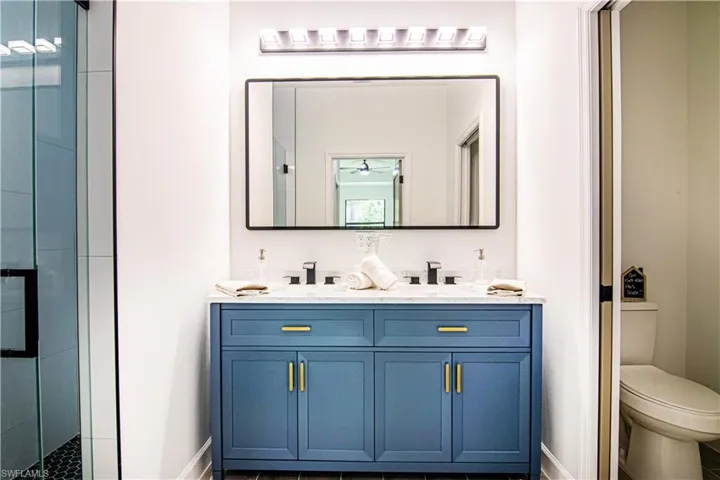 Bathroom with walk in shower, vanity, and toilet
