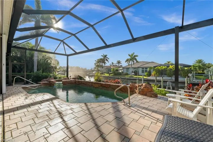 View of swimming pool with a lanai, a sunroom, a patio, and a pool with connected hot tub