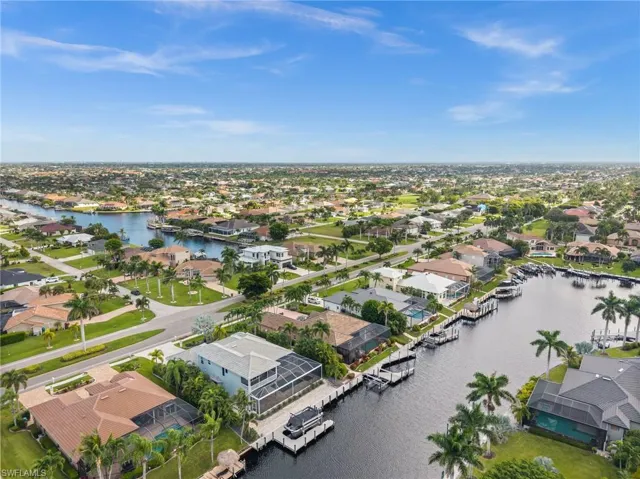 Aerial perspective of suburban area featuring a nearby body of water
