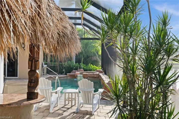 View of pool featuring a lanai, a patio, and a pool with connected hot tub