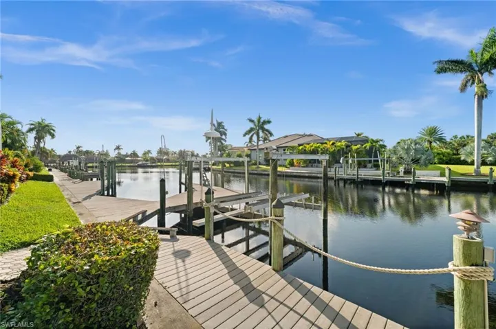 Dock area featuring boat lift and a water view
