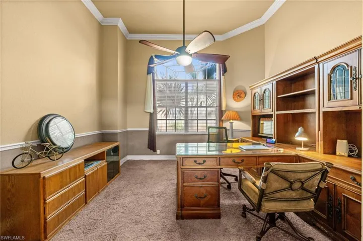 Home office featuring ornamental molding and light colored carpet