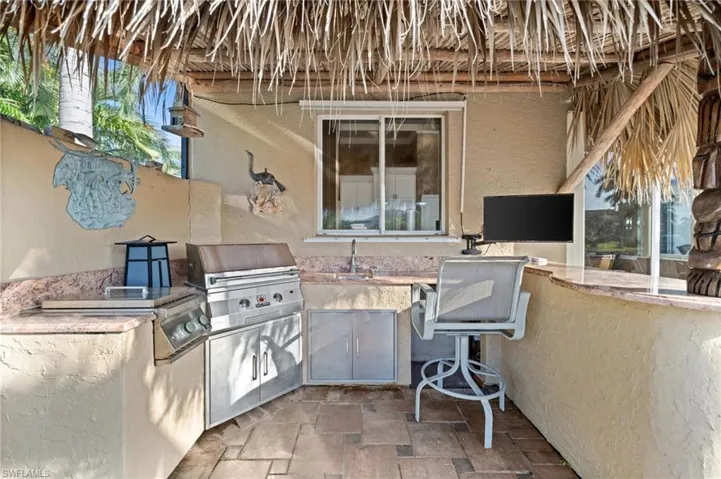View of patio featuring an outdoor kitchen and a sink
