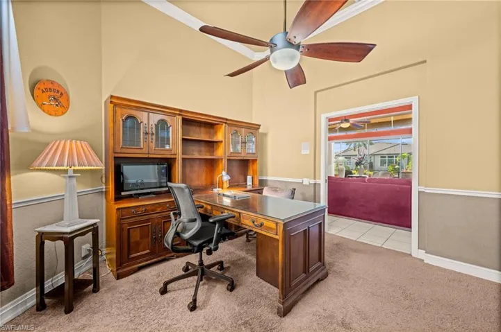 Office featuring light carpet, a ceiling fan, and light tile patterned flooring