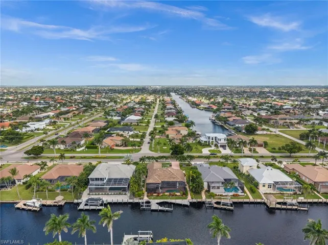 Aerial overview of property's location with nearby suburban area and a large body of water