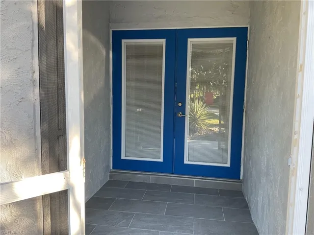 Property entrance featuring french doors and stucco siding