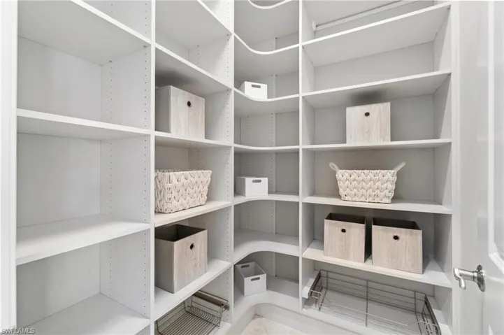 An abundance of custom shelving in the kitchen pantry