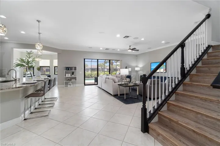 Wood-like covered stairs adorn the main living space welcoming family and/or guests