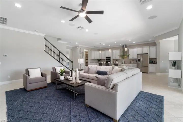 Spacious main living area is adorned with crown molding and open kitchen