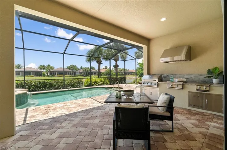 Full outdoor kitchen welcomes poolside entertaining