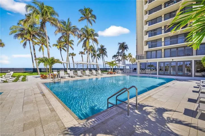 Community pool with a patio overlooking the Gulf