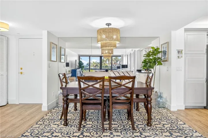 Dining area with light wood-style floors and baseboards