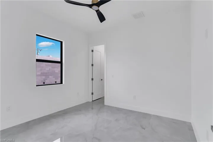 Empty room featuring ceiling fan