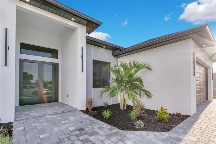 View of exterior entry with a garage