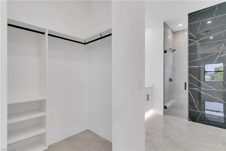 Walk in closet featuring a barn door