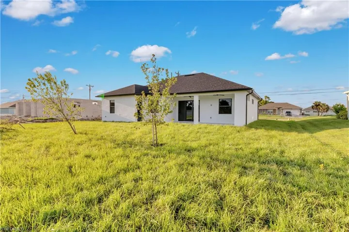 Rear view of property featuring a lawn