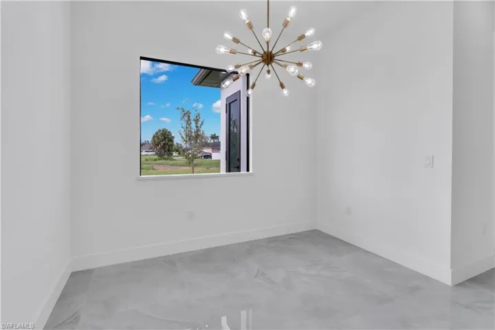 Unfurnished room with a chandelier