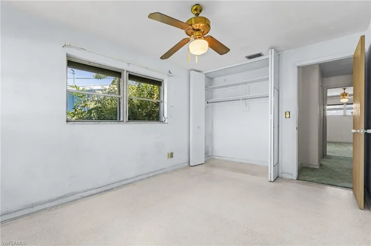 bedroom number 3 with ceiling fan and a closet and terrazzo flooring